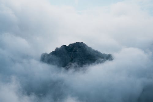 Free Rocky Mountain Over White Clouds Stock Photo