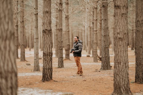 Adult man in barren forest