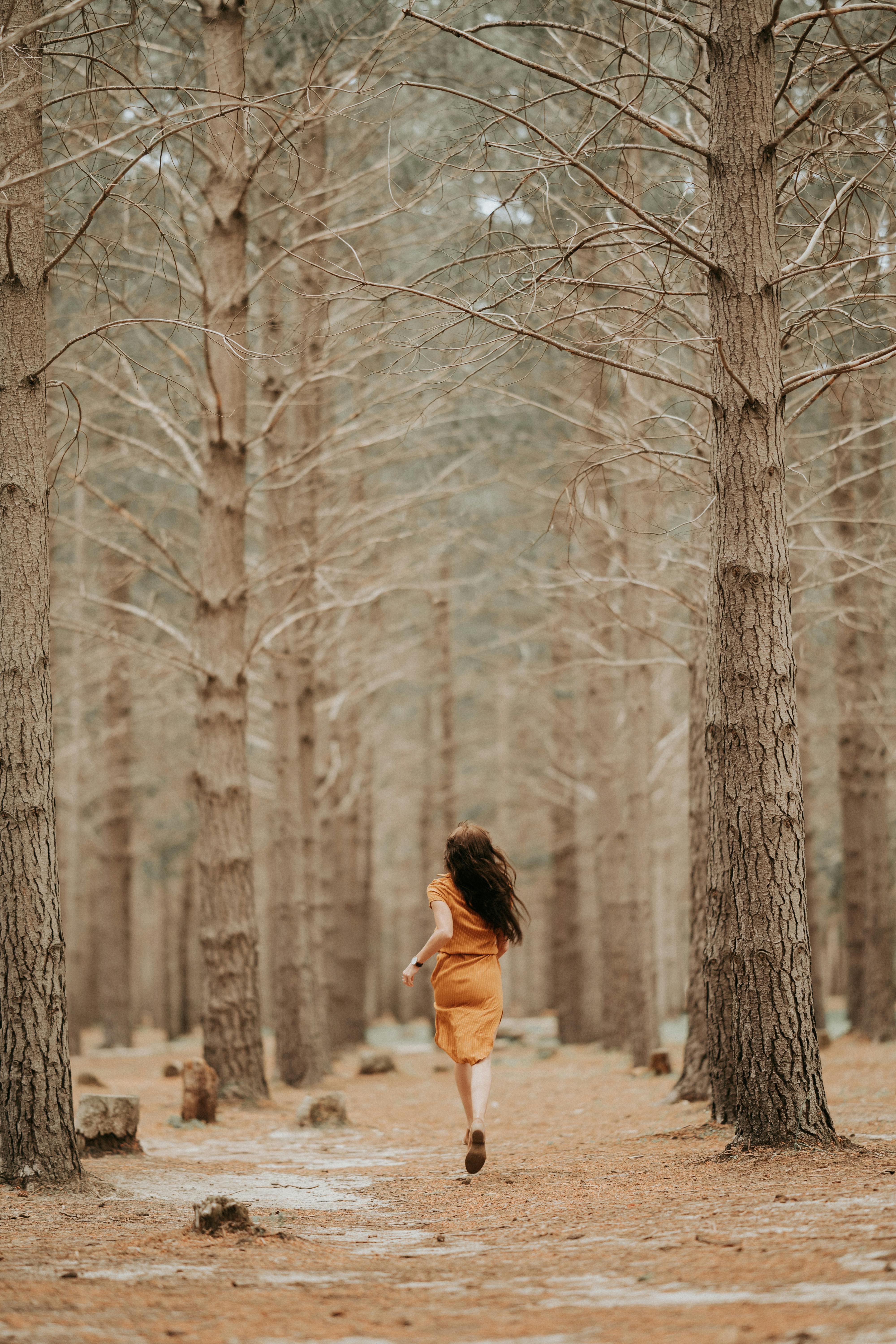 adult woman running in forest