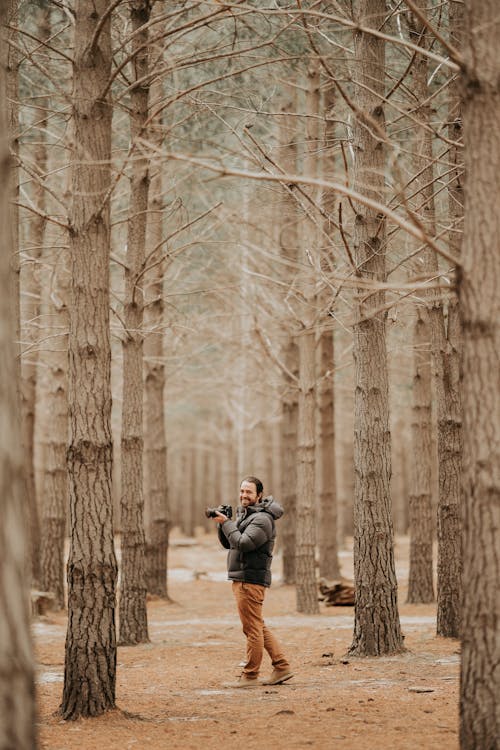 Adult man with camera in forest