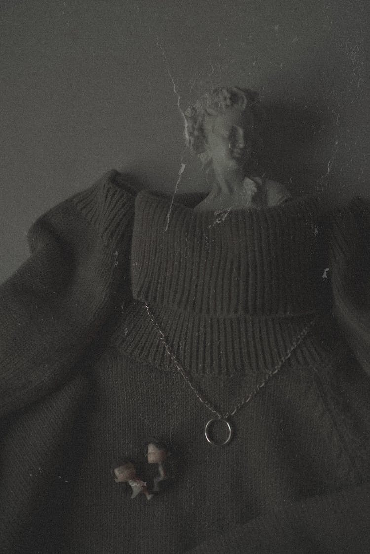 Turtleneck Sweater, Necklace And A Little Figurine 