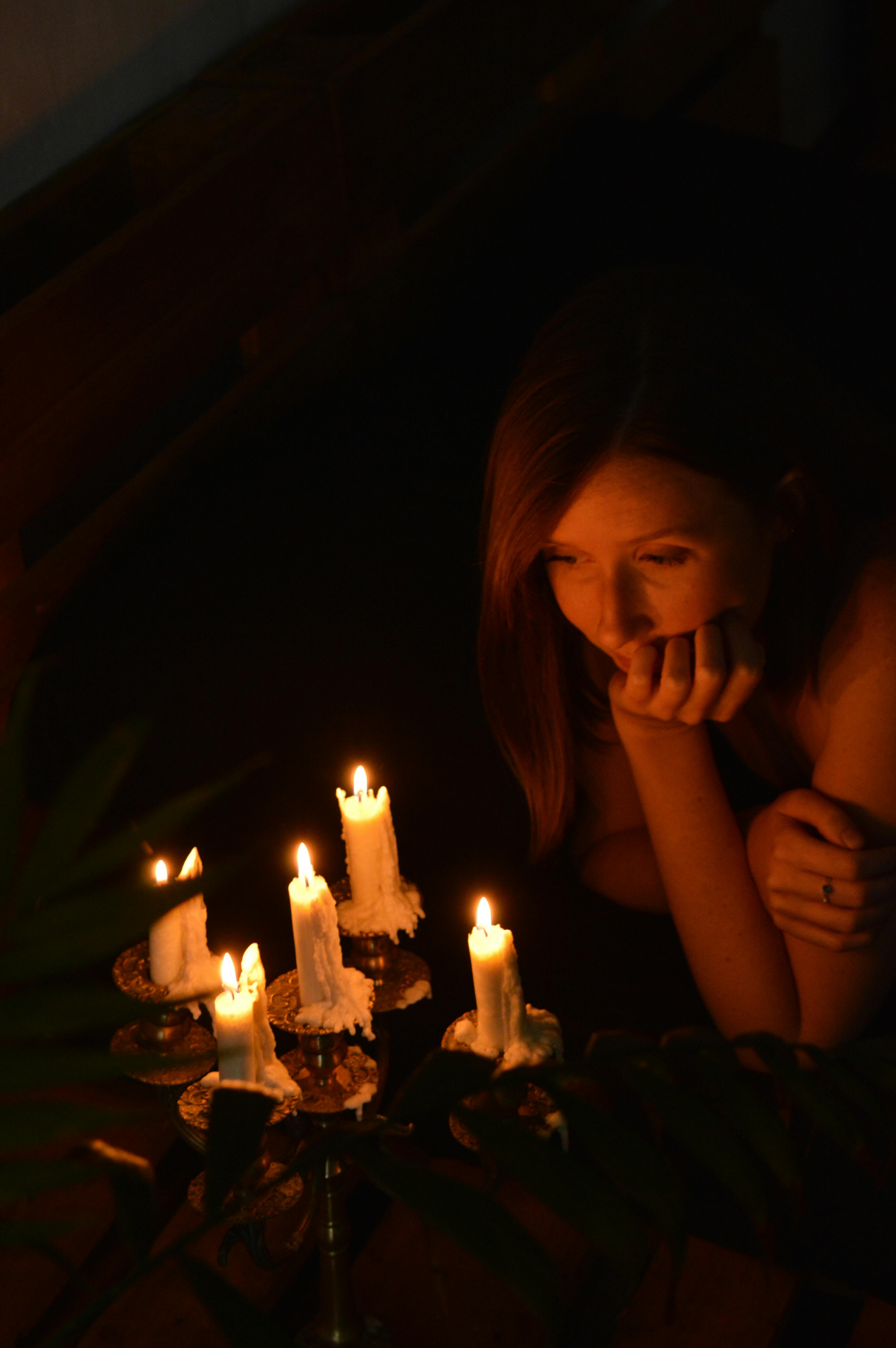 woman looking at the lighted candles