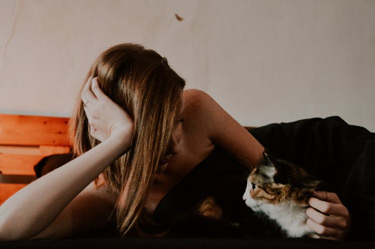 Woman Lying Down With Cat