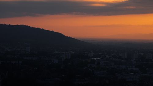 Free Beautiful aerial sunset view over Freiburg cityscape with silhouetted hills. Stock Photo