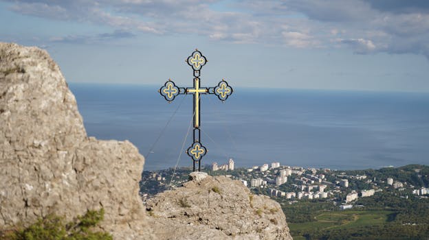 A dramatic cross atop a cliff with a city and sea backdrop, symbolizing faith and serenity.
