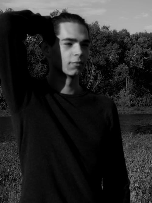 Grayscale Photo of a Man Wearing a Black Long Sleeve Shirt