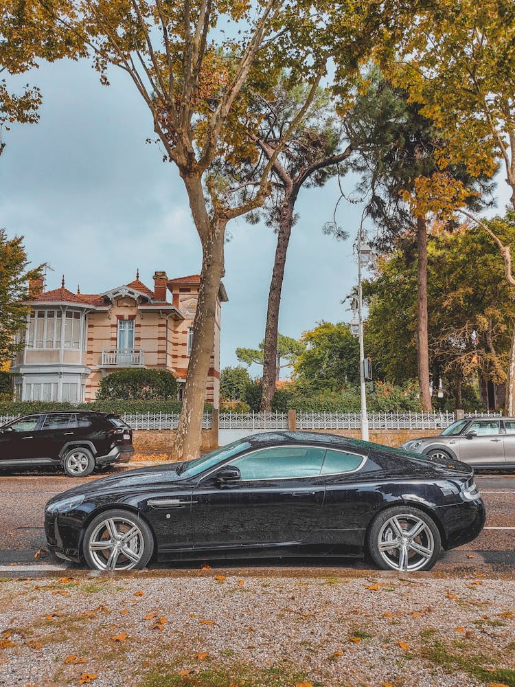 Side View Of An Aston Martin Car Parked On The Road