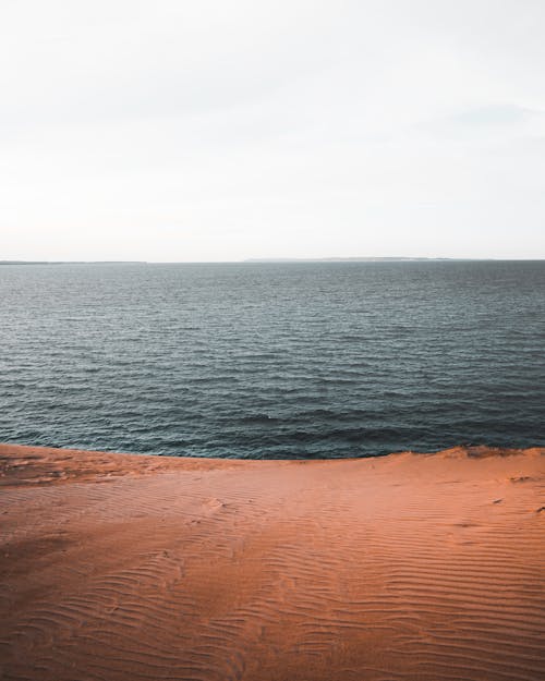 Body of Water Under White Sky