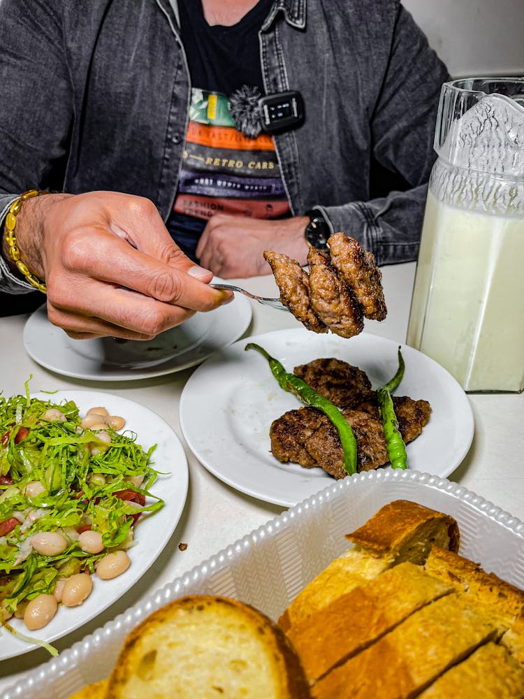 Man At A Table Eating 