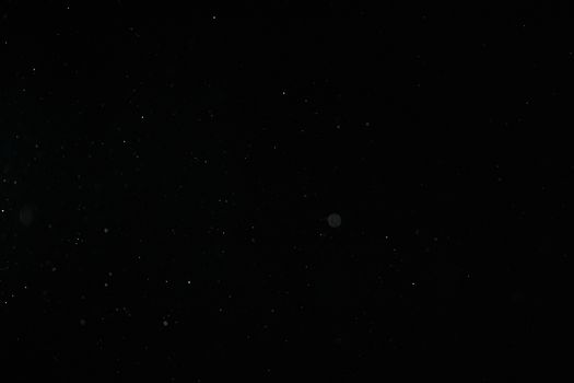 Creative abstract image of particles on a black background resembling a starry night sky.