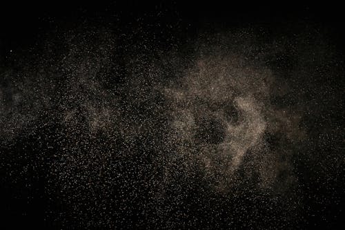 White Dust Particles on Black Background