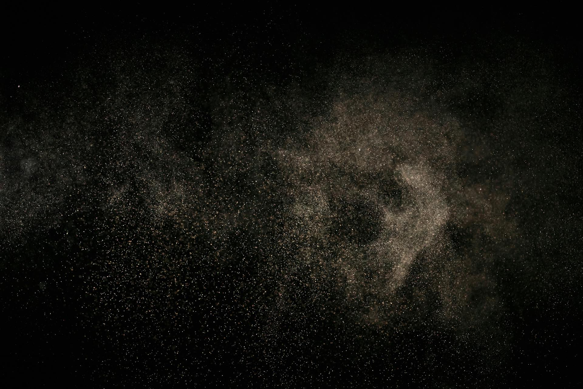 White Dust Particles on Black Background