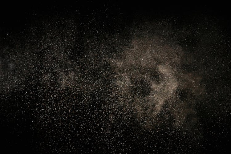 White Dust Particles On Black Background