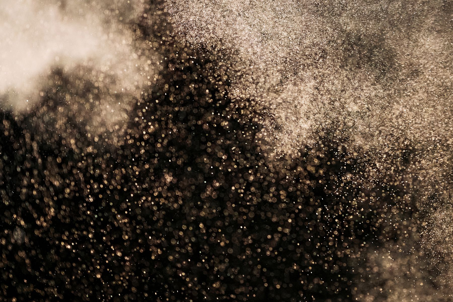 Abstract gold particles on dark background