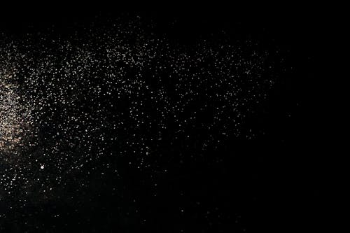 White Dust Particles on Black Background