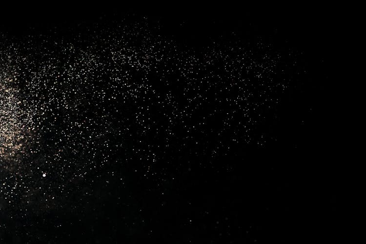 White Dust Particles On Black Background