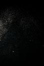 Tiny White Dust Particles on Black Background