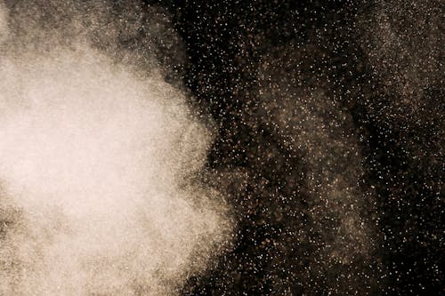 White Dust Particles on Black Background