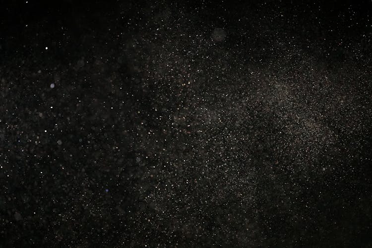 White Dust Particles On Black Background