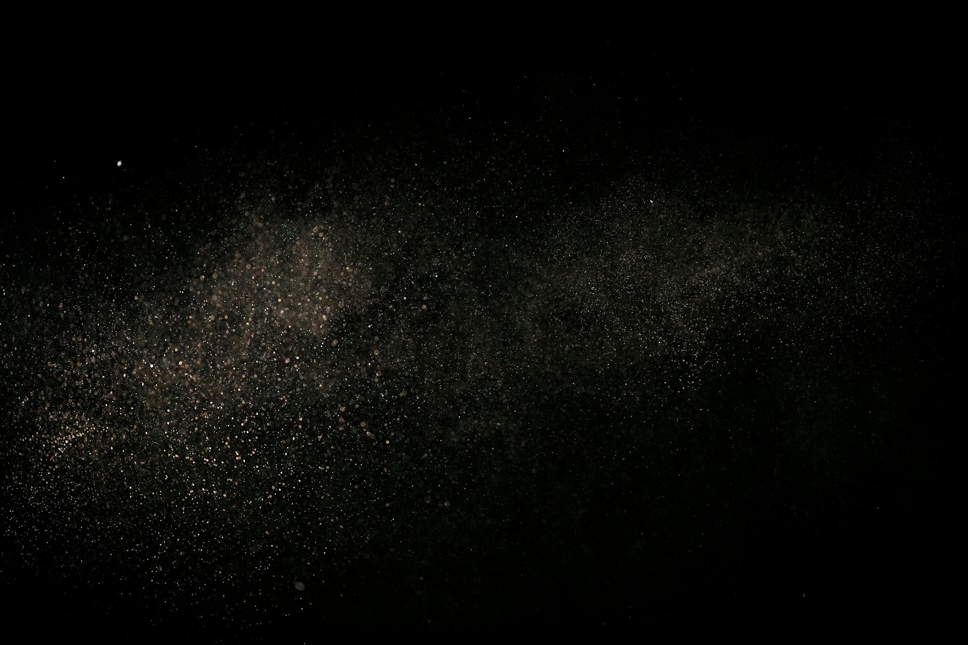 White Dust Particles on Black Background