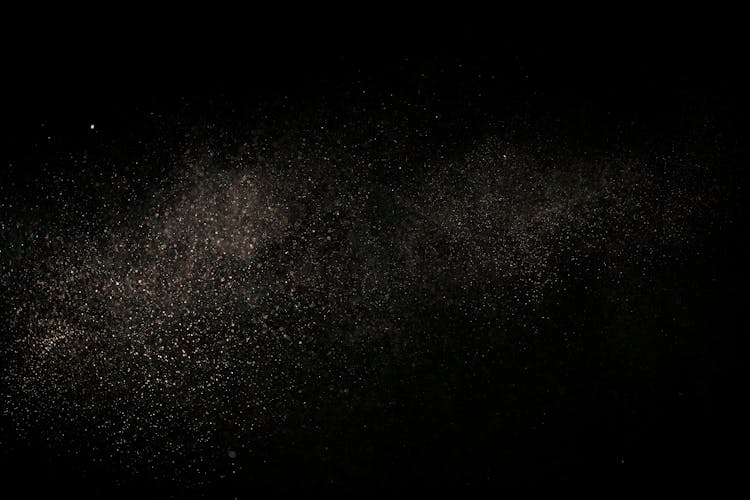 White Dust Particles On Black Background