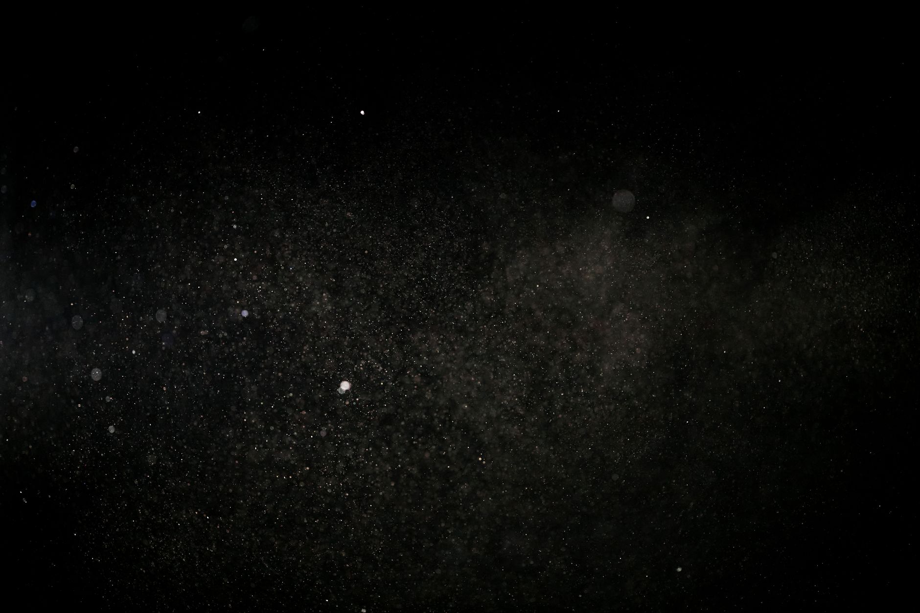 Fine particles suspended against a dark background