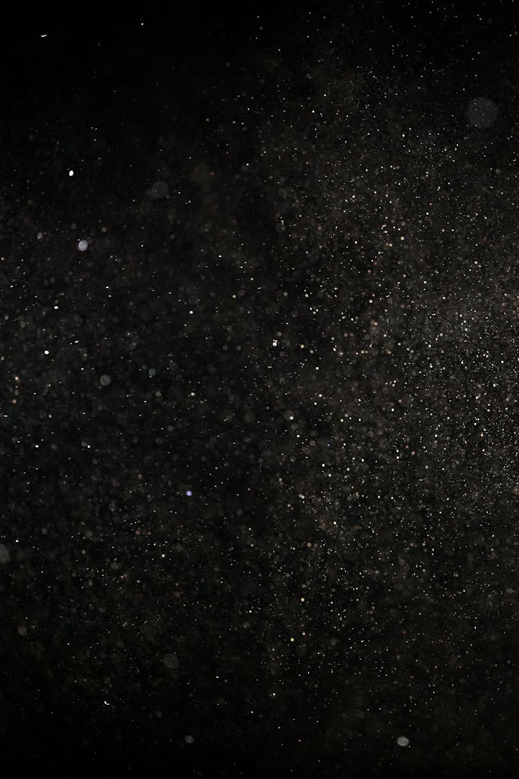 White Dust Particles On Black Background