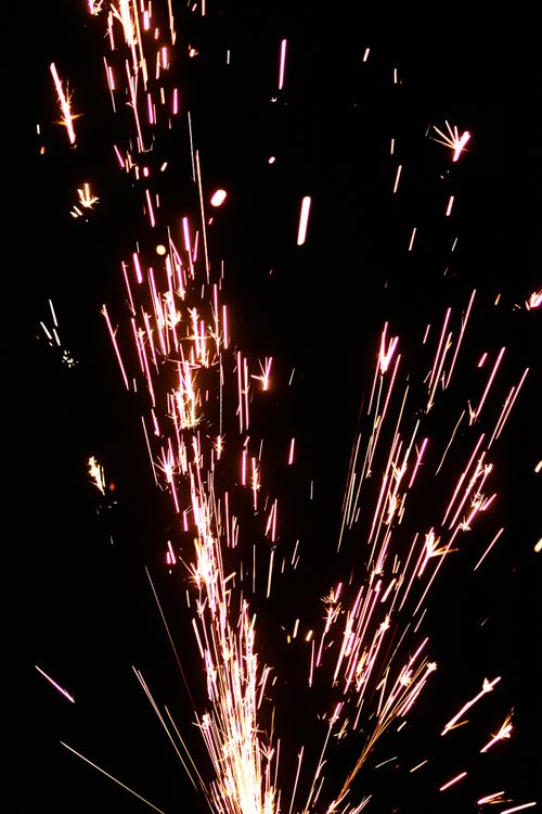 Free Dazzling sparks from fireworks display against a black sky, ideal for celebration themes. Stock Photo