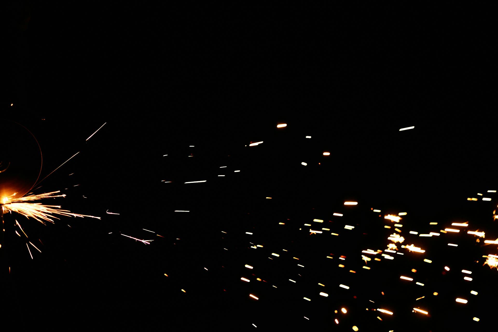 Flashing Sparks on Black Background