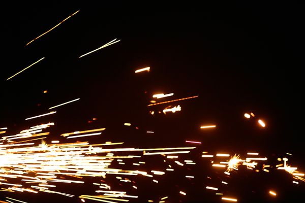 Close-up of flashing sparks against a black background