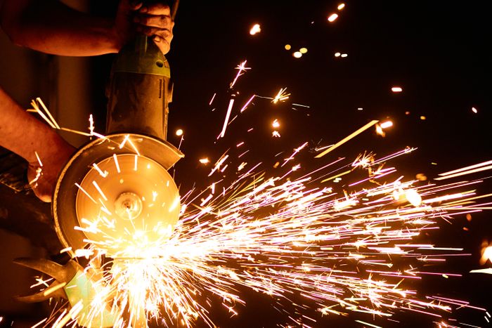 Power grinding a steel fabrication smooth