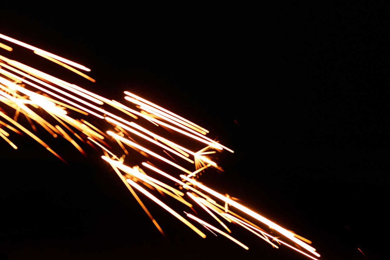 close up of sparks in motion on a black background showcasing dynamic