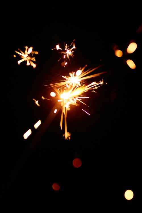 Free Captivating close-up of a burning sparkler with dazzling effects on a dark backdrop. Stock Photo