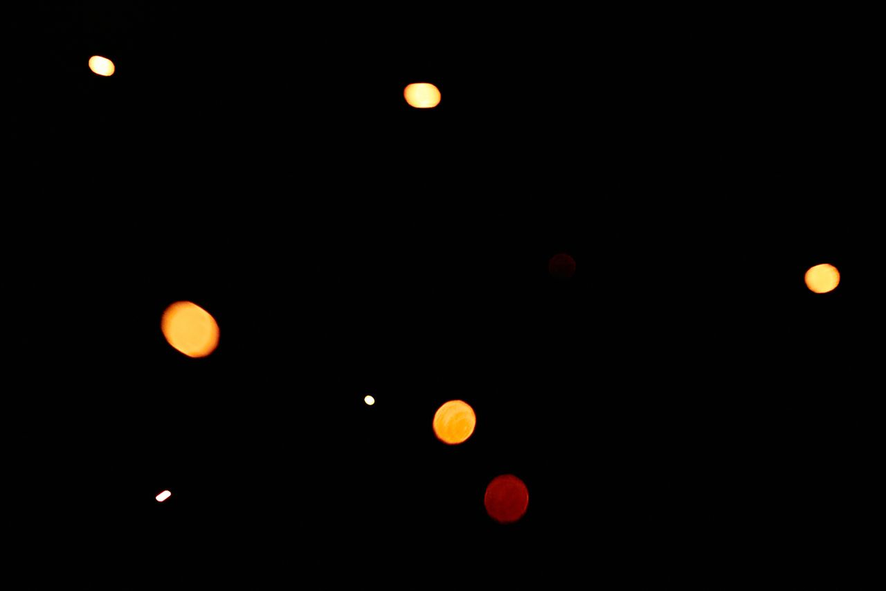 abstract glowing bokeh lights against a dark background perfect for cr