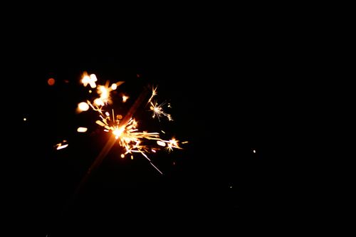 Free A stunning close-up of a sparkler against a black background, creating a dazzling light show. Stock Photo