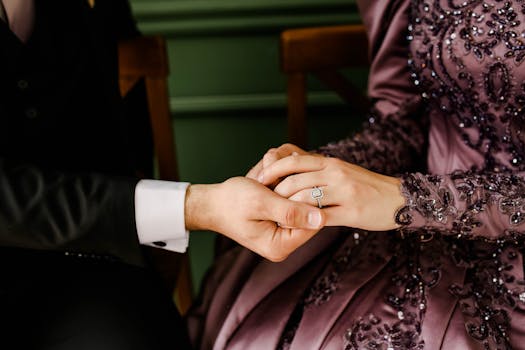 Close-up of a couple holding hands with a focus on a sparkling engagement ring, showcasing love and togetherness.