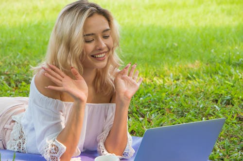 Happy Woman Looking at the Screen of a Laptop