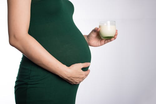 Pregnant Woman Holding a Glass of Milk