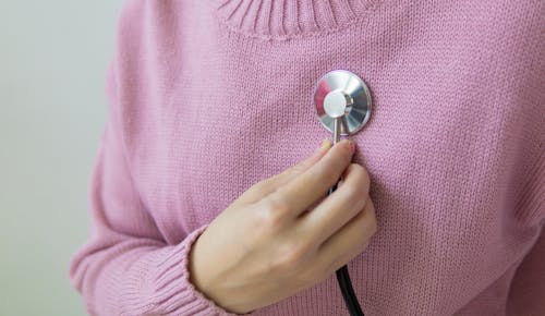 Woman in pink Sweater Holding a Stethoscope