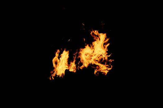 Vivid flames isolated against a black backdrop, showcasing heat and energy.