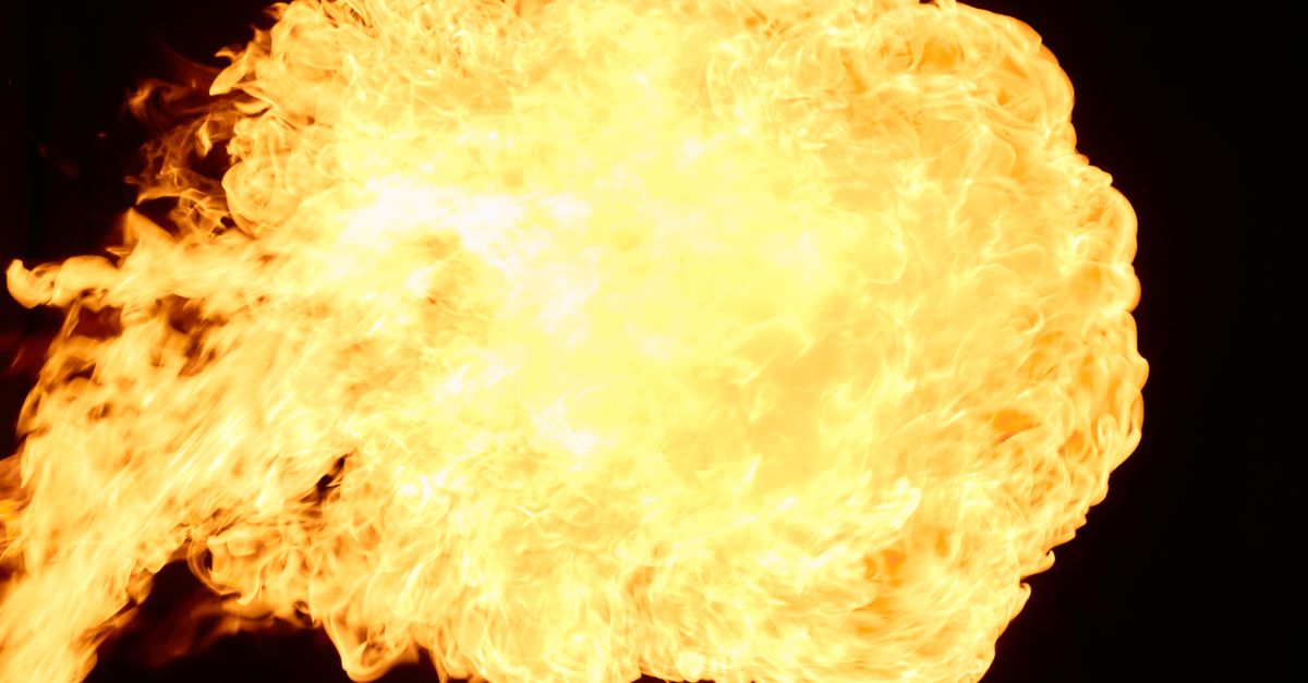 Dynamic fireball explosion with intense flames against a black background, showcasing heat and energy.