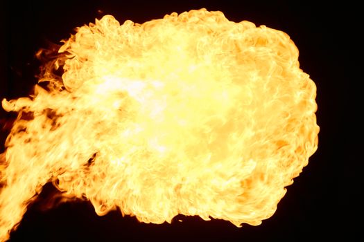 Dynamic fireball explosion with intense flames against a black background, showcasing heat and energy.