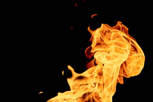Vivid flames with intricate patterns against a dark backdrop, capturing the essence of fire.