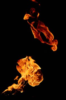 Vibrant flames dancing on a black background, showcasing fiery textures.