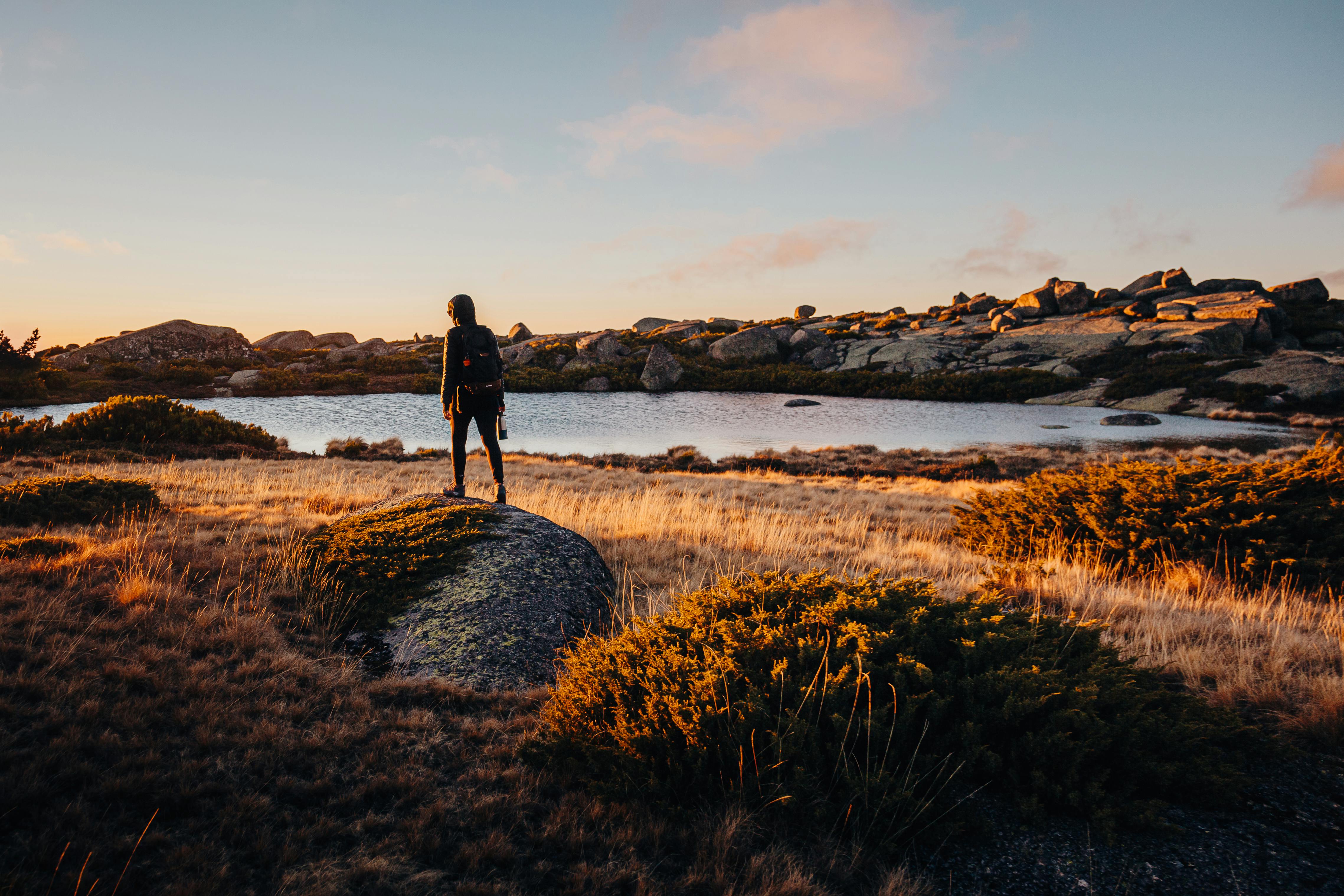 A Girl in a Bright Yellow Hoodie with a Smile on Her Face Sits on a Lake in  the Mountains and Looks at the Smartphone Stock Photo - Image of lake,  landscape