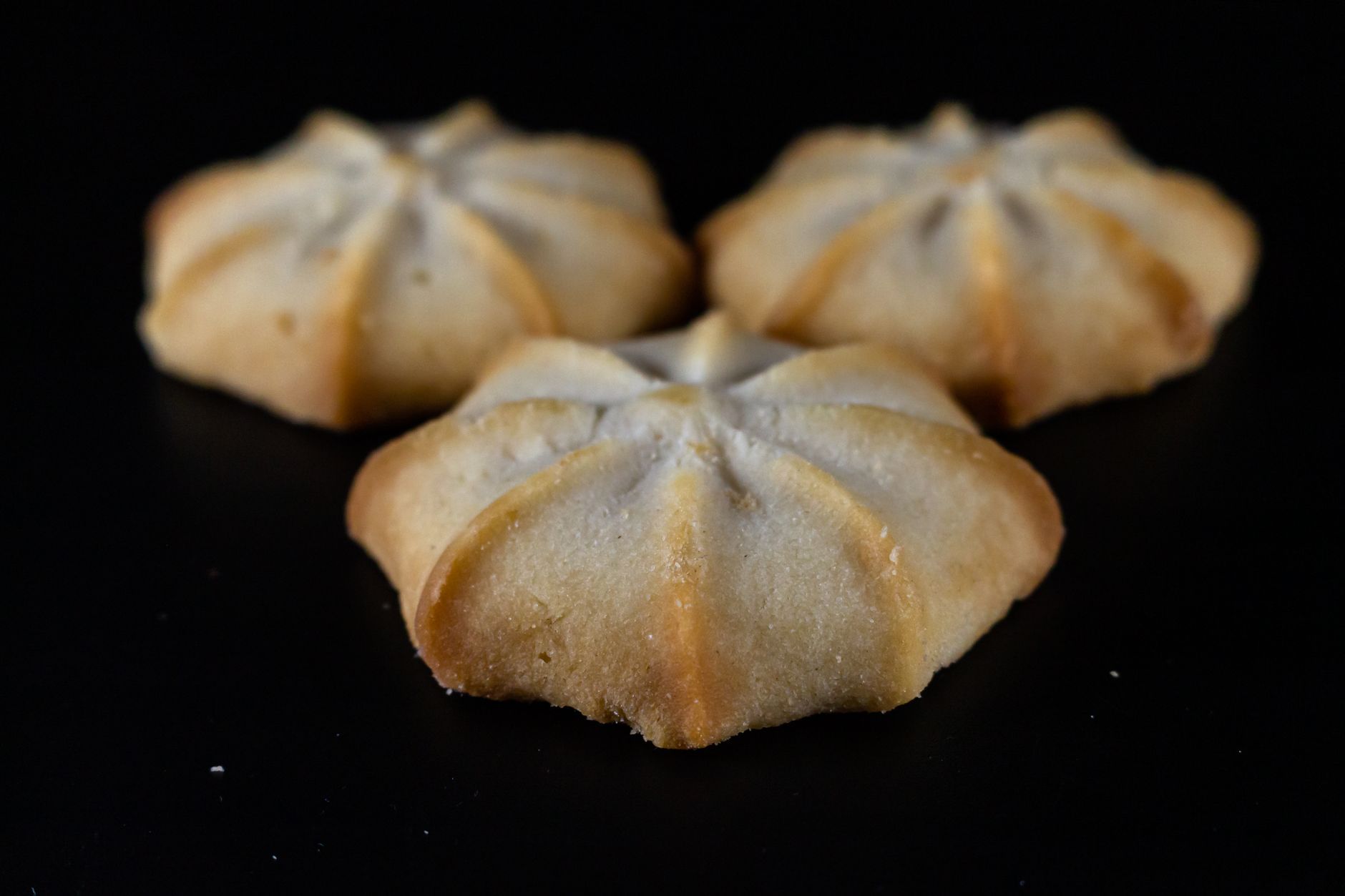 Freshly baked almond flour shortbread cookies cooling on a rack
