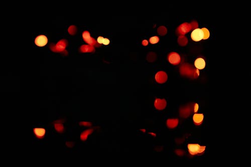 Unfocused blur orange light dots on black background