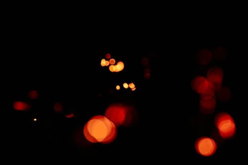 Unfocused blur orange light dots on black background