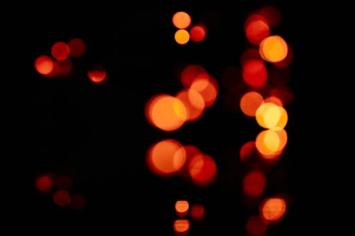 Unfocused blur orange light dots on black background 