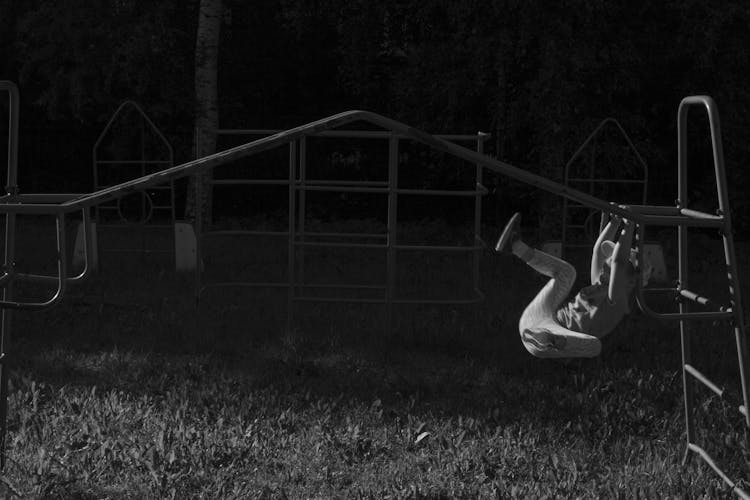 Child Playing On The Monkey Bar